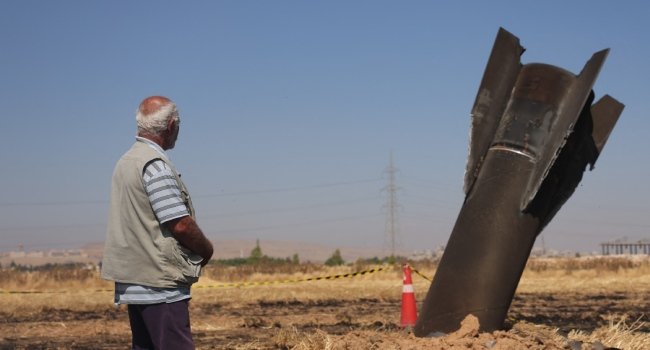 A-Syrian-farmer-looks-at-an-Iranian-missile-that-fell-into-an-agricultural-land-in-the-area-of-Najha